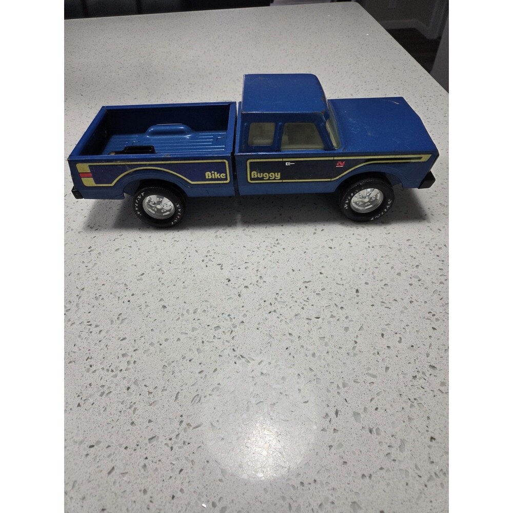 a vintage 1970s Nylint "Bike Buggy" pressed steel Ford pickup truck. [1]
